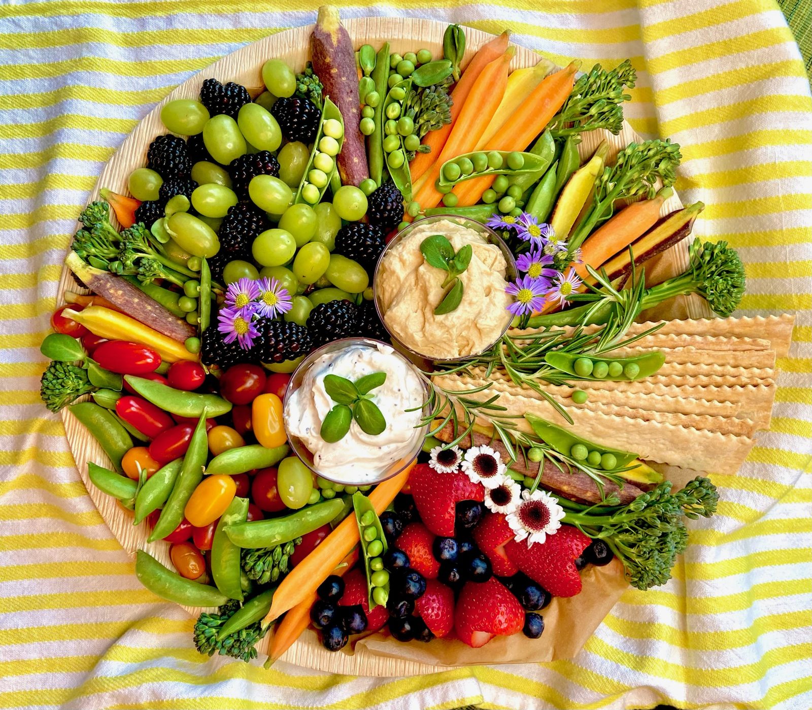 Crudités platter with dips, heirloom vegetables, and edible flowers