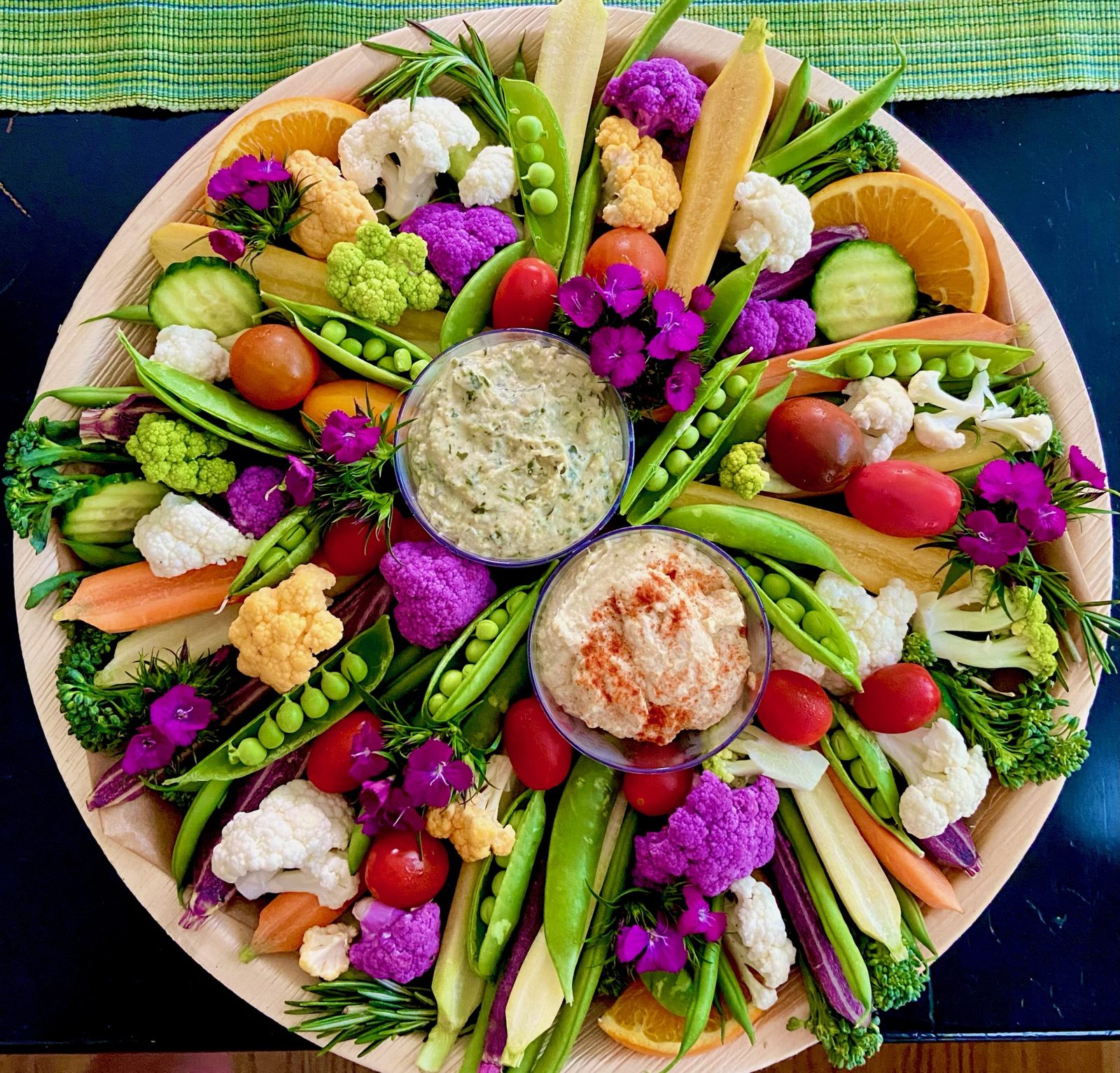 Round vegetable and dip platter with cauliflower, peas, and carrots