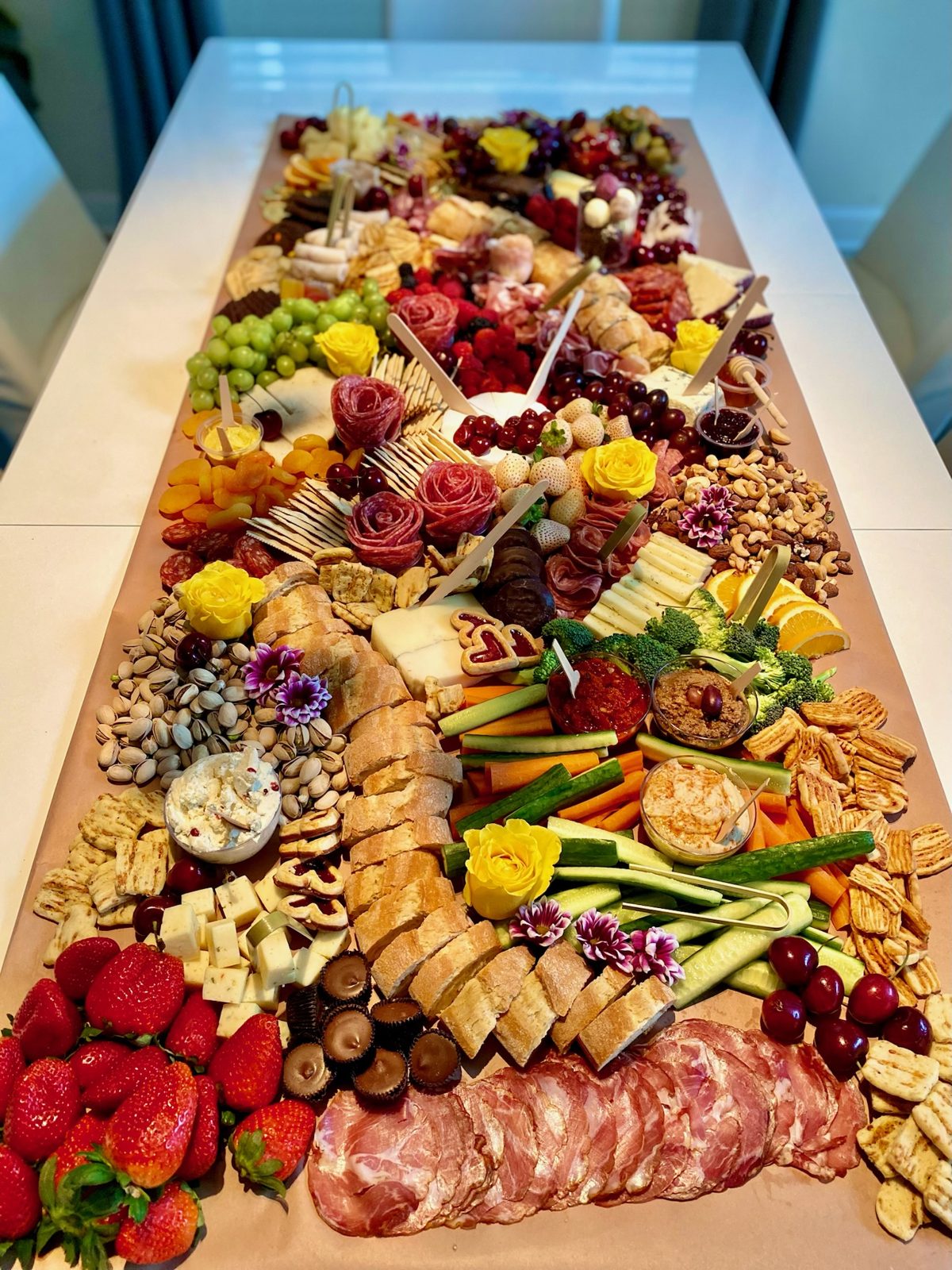 Grazing table with berries, cured meats, cheeses, and crackers