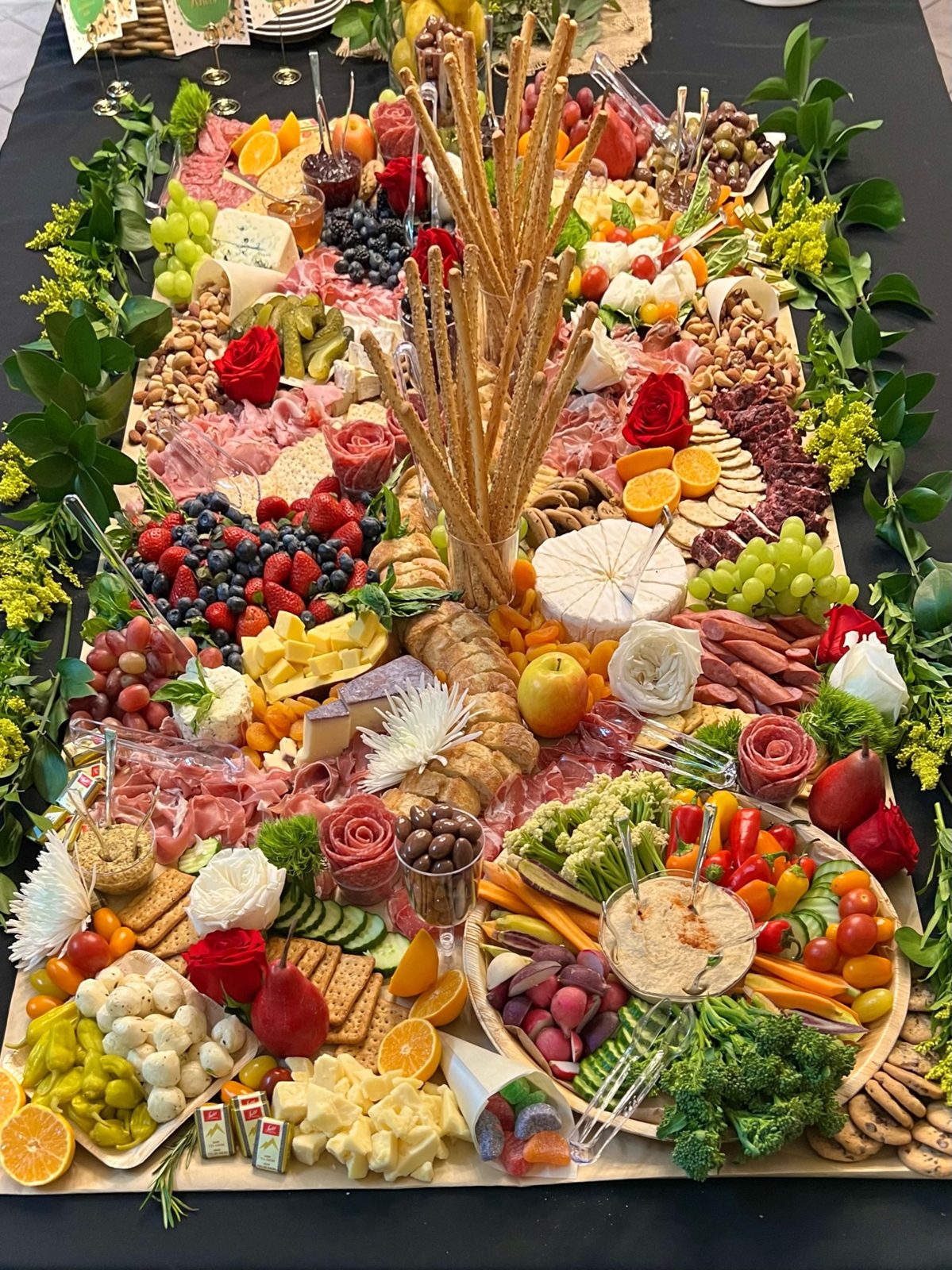 Reception grazing display with wheat accents, berries, and cheeses